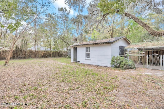 view of yard with fence and an outbuilding