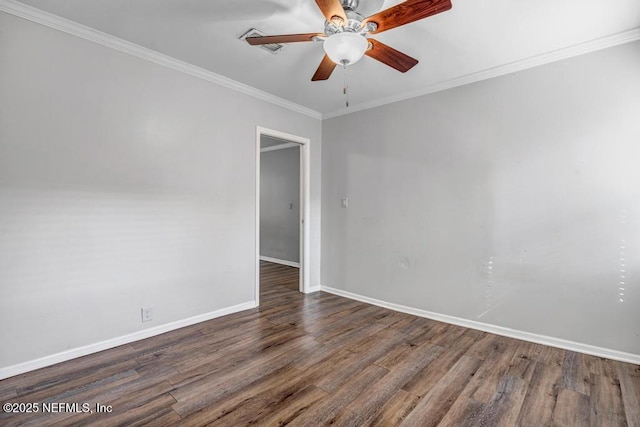 empty room with ornamental molding, wood finished floors, a ceiling fan, and baseboards