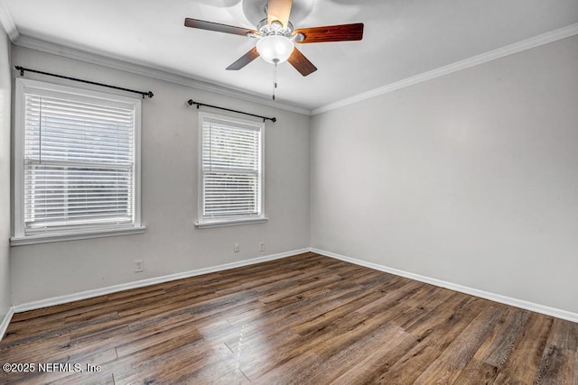 spare room featuring crown molding, baseboards, ceiling fan, and wood finished floors