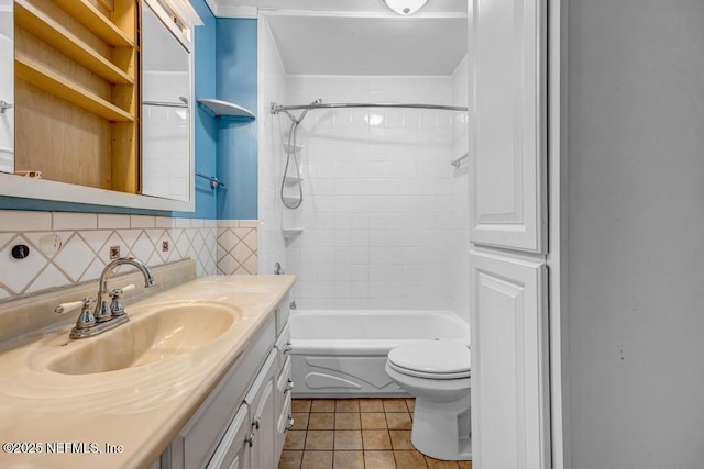 bathroom with tile walls, shower / bath combination, toilet, vanity, and tile patterned floors