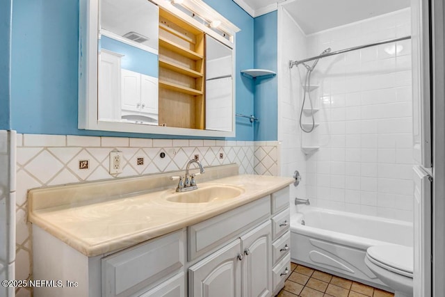 bathroom with bathtub / shower combination, toilet, tile patterned flooring, visible vents, and vanity