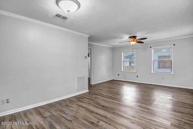 empty room with baseboards, visible vents, and wood finished floors