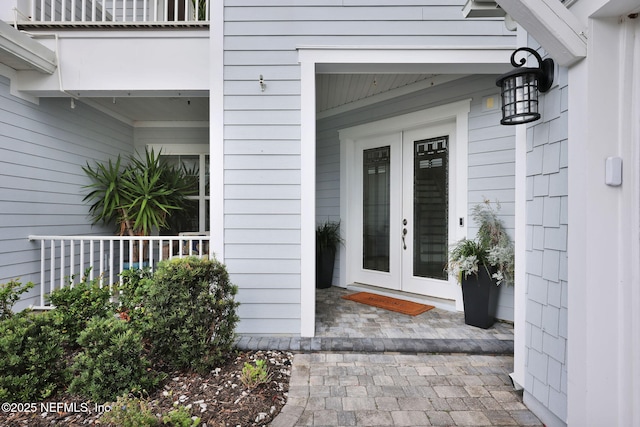 doorway to property featuring a porch and french doors