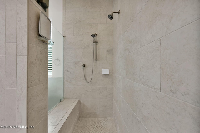 bathroom with a tile shower