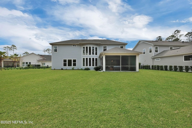 back of house featuring a sunroom and a yard