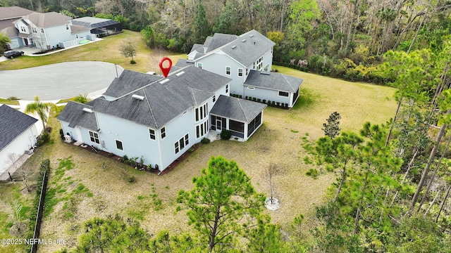 birds eye view of property with a forest view