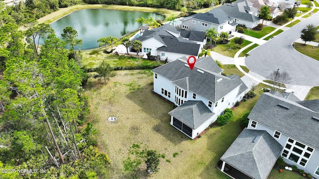 bird's eye view with a water view and a residential view