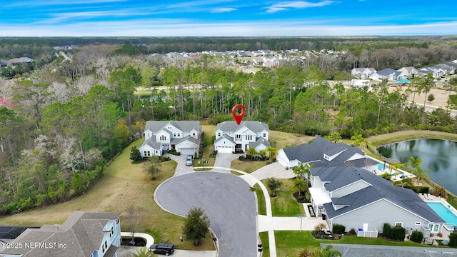 bird's eye view with a forest view, a water view, and a residential view