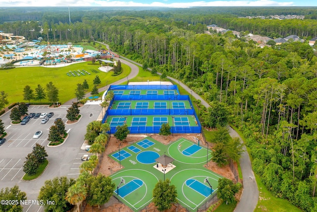 birds eye view of property featuring a wooded view