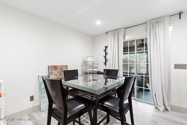 dining space with light wood-style floors, recessed lighting, and baseboards