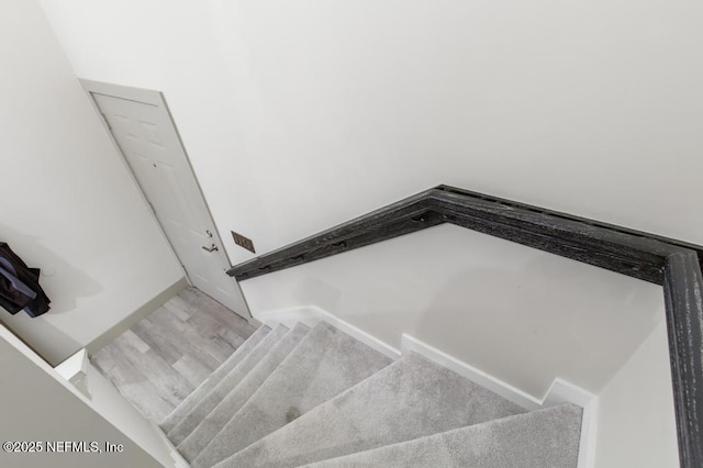 stairs featuring wood finished floors