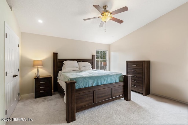 bedroom with light carpet, ceiling fan, lofted ceiling, and baseboards