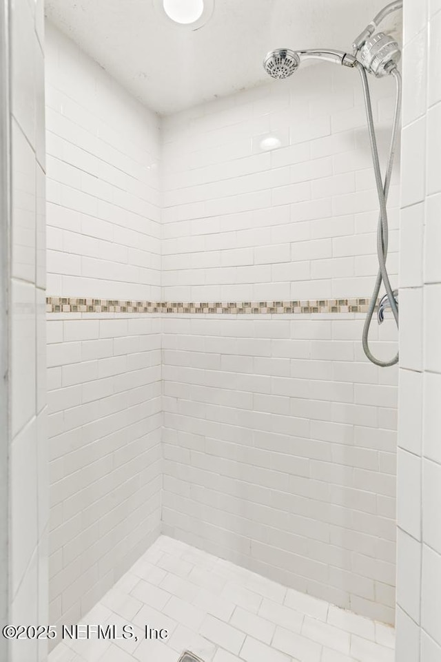 bathroom with a tile shower