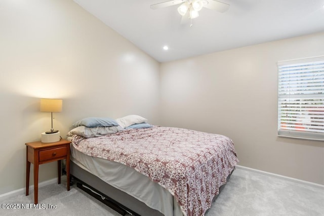 carpeted bedroom with a ceiling fan, lofted ceiling, and baseboards