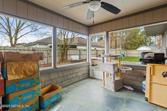 sunroom with plenty of natural light and a ceiling fan