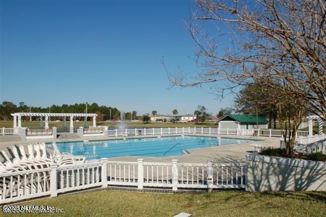 pool featuring a patio area, fence, and a pergola