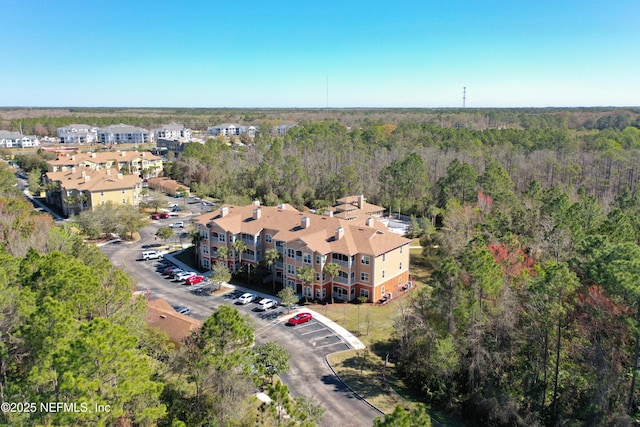 aerial view featuring a wooded view