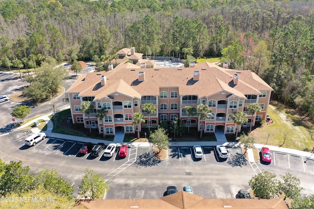 drone / aerial view featuring a view of trees