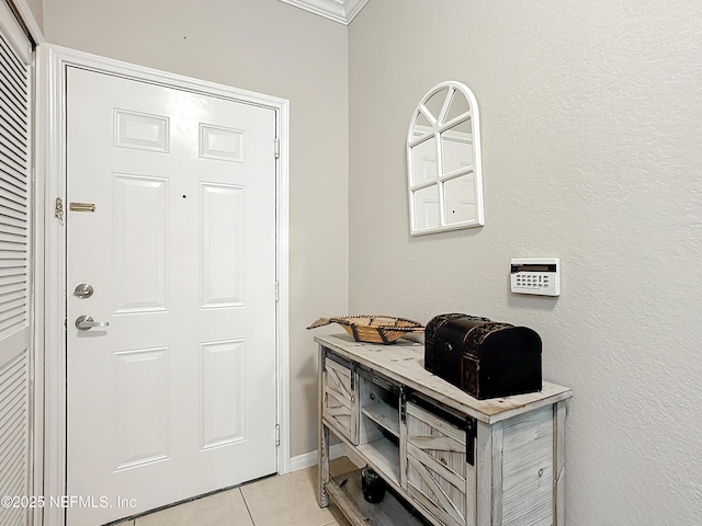 entrance foyer featuring light tile patterned floors and baseboards