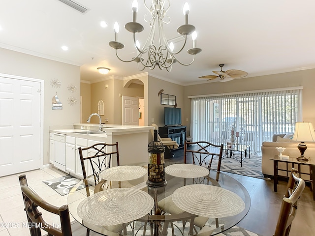 dining room featuring visible vents, arched walkways, baseboards, ornamental molding, and ceiling fan with notable chandelier