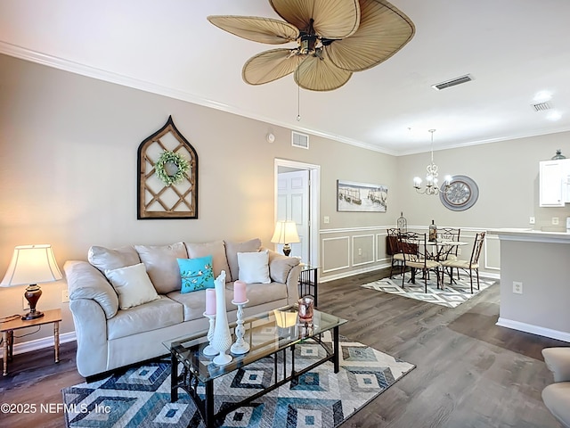 living room with visible vents, dark wood finished floors, and crown molding