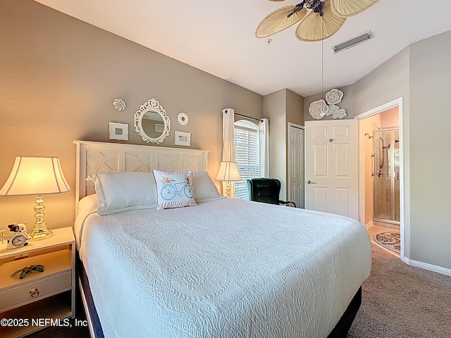 carpeted bedroom with baseboards, visible vents, and ensuite bathroom