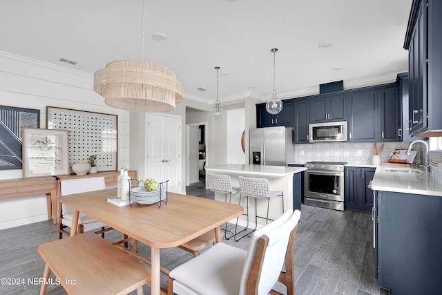 dining space with wood tiled floor, visible vents, and crown molding