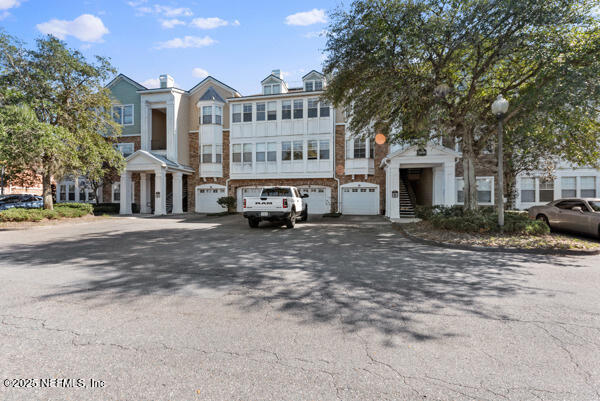 view of front of house featuring an attached garage and stairway