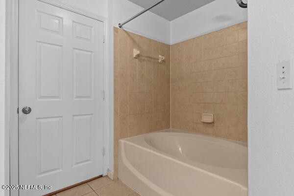 full bath with shower / washtub combination and tile patterned floors