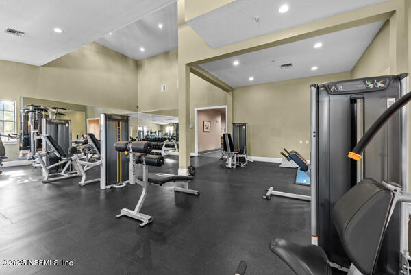 workout area featuring baseboards, visible vents, and recessed lighting