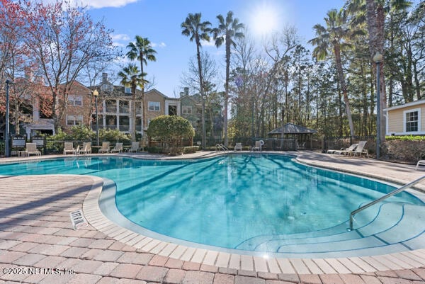 pool featuring a patio area, fence, and a gazebo