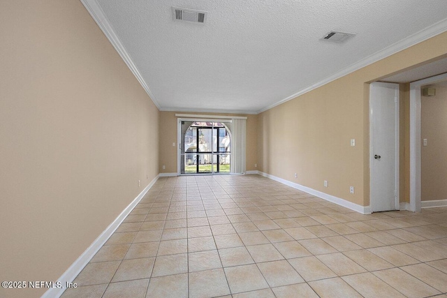 spare room featuring light tile patterned floors, visible vents, and crown molding