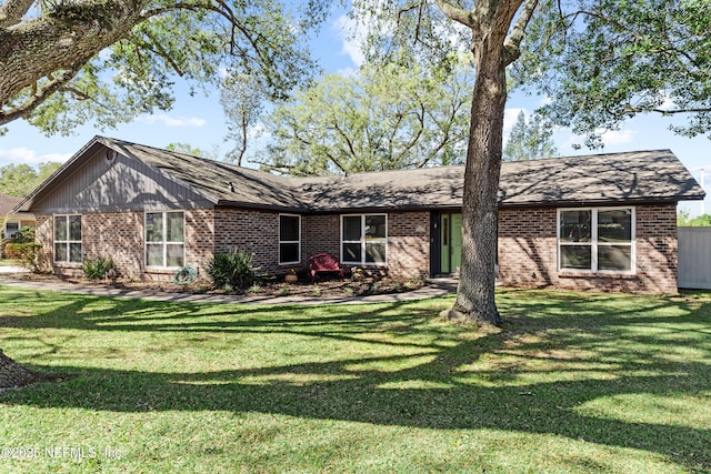 view of front of property featuring a front lawn and brick siding