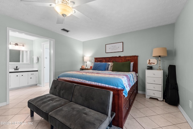 bedroom with visible vents, a textured ceiling, and light tile patterned flooring