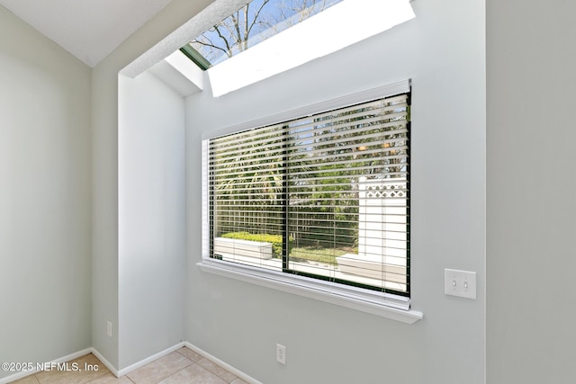 interior details with a skylight and baseboards