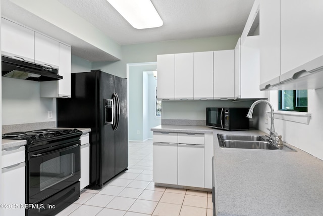 kitchen with a sink, black appliances, light countertops, under cabinet range hood, and white cabinetry