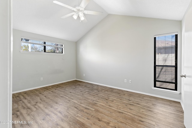 empty room with vaulted ceiling, wood finished floors, and a ceiling fan