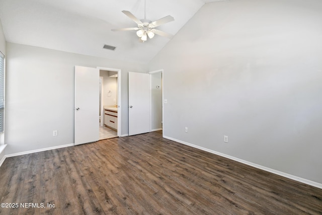 unfurnished bedroom with dark wood-type flooring, baseboards, visible vents, and high vaulted ceiling