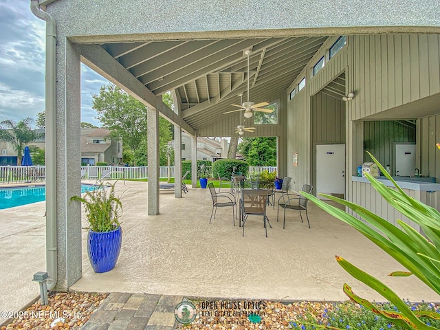 view of patio / terrace featuring outdoor dining space, a ceiling fan, a fenced in pool, and a fenced backyard