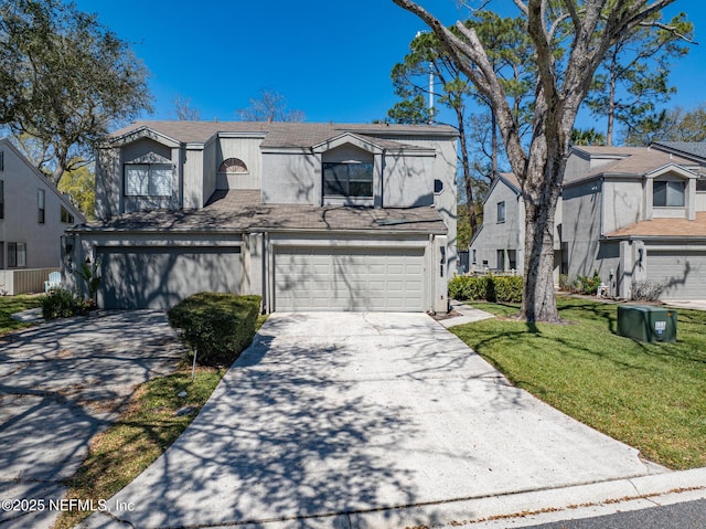 view of front of home with a front lawn, a garage, and driveway