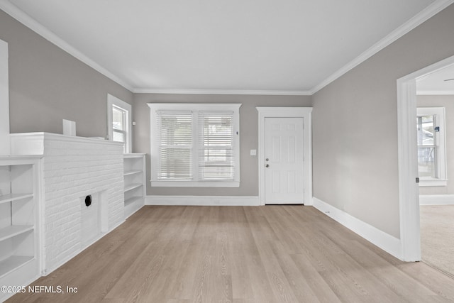 entrance foyer with a healthy amount of sunlight, baseboards, ornamental molding, and wood finished floors