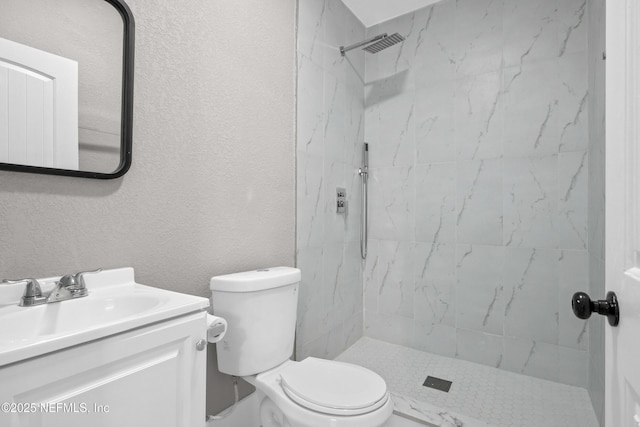 full bath with toilet, a textured wall, tiled shower, and vanity