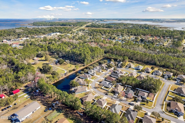 drone / aerial view with a residential view and a water view