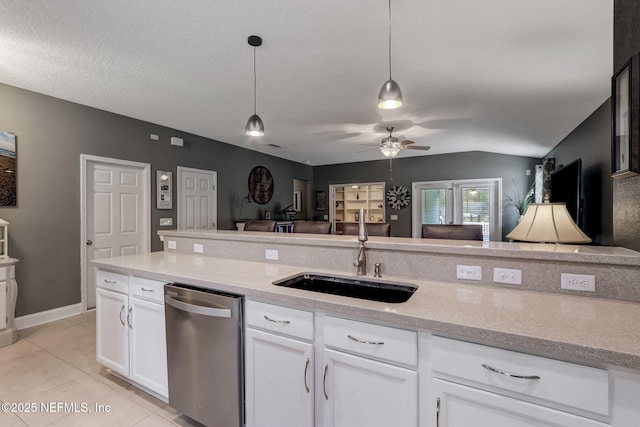 kitchen with a sink, decorative light fixtures, light tile patterned flooring, white cabinets, and dishwasher