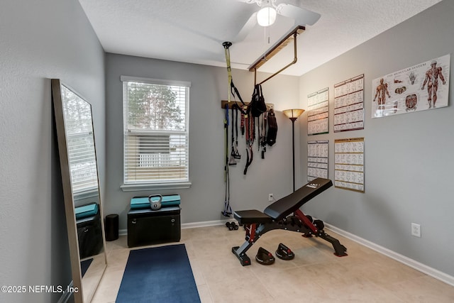 exercise room with tile patterned floors, baseboards, a textured ceiling, and ceiling fan