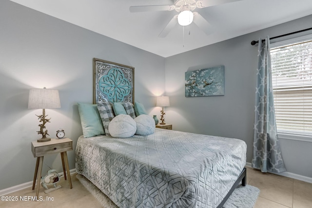 tiled bedroom with baseboards and a ceiling fan