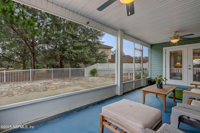 unfurnished sunroom featuring ceiling fan