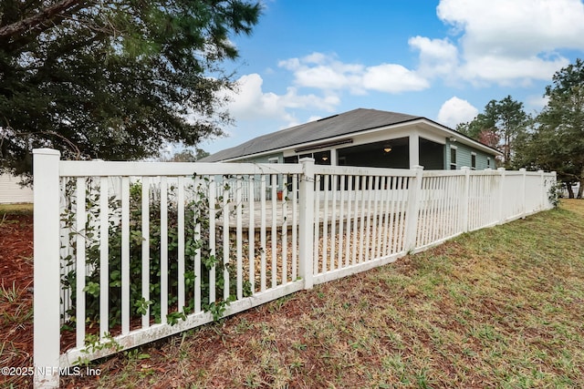 view of side of property with a wooden deck and fence