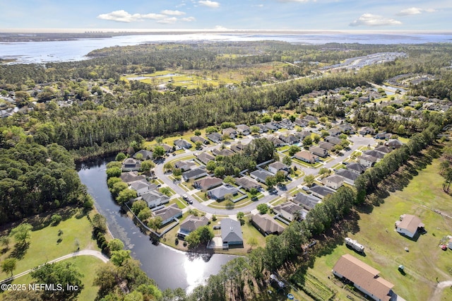 drone / aerial view with a residential view and a water view