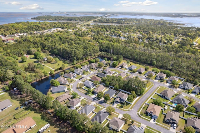 bird's eye view featuring a residential view, a water view, and a view of trees